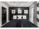 Stylish bedroom with a black accent wall, decorative masks, and modern light fixture at 2505 Astaire Nw Ct, Atlanta, GA 30318