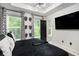 Modern bedroom with black and white decor, large windows, and modern TV at 2505 Astaire Nw Ct, Atlanta, GA 30318