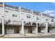 Modern townhome exteriors showcasing private decks, black railings, and convenient attached garages at 2505 Astaire Nw Ct, Atlanta, GA 30318