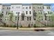 Beautiful three-story townhomes with brick and siding, landscaped with trees and greenery at 2505 Astaire Nw Ct, Atlanta, GA 30318