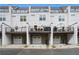 Exterior shot of modern townhomes with private back decks and attached garages, offering urban living at 2505 Astaire Nw Ct, Atlanta, GA 30318