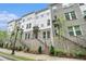 Charming three-story brick townhomes with landscaped front yards and secure entrances at 2505 Astaire Nw Ct, Atlanta, GA 30318