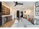 Living room with a large gray sofa, wet bar, and backyard view at 2505 Astaire Nw Ct, Atlanta, GA 30318