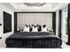 Luxurious main bedroom with a padded headboard, modern chandelier, and natural light at 2505 Astaire Nw Ct, Atlanta, GA 30318