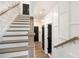 Elegant staircase with white risers, wood treads, and a stylish handrail create a modern aesthetic at 2505 Astaire Nw Ct, Atlanta, GA 30318