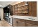 Wet bar features an elegant countertop, wooden cabinets, and a wine fridge at 2505 Astaire Nw Ct, Atlanta, GA 30318