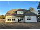 Back exterior view of a home with a covered patio and large windows overlooking the yard at 3000 Keeneland Blvd, Mcdonough, GA 30252