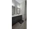 Modern bathroom featuring a double vanity with sleek gray cabinets and wood-look flooring at 3000 Keeneland Blvd, Mcdonough, GA 30252