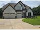 Charming two-story home featuring a three car garage, manicured lawn, and craftsman style architecture at 3000 Keeneland Blvd, Mcdonough, GA 30252
