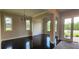 Bright, open living room with hardwood floors, elegant chandeliers, and large windows overlooking the outdoors at 3000 Keeneland Blvd, Mcdonough, GA 30252