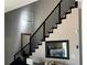 Contemporary staircase with black railings and an open view of the living area at 3000 Keeneland Blvd, Mcdonough, GA 30252