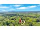 Expansive aerial view showcasing the property's location amidst lush trees with distant mountain views at 316 Shiloh Hills Nw Dr, Kennesaw, GA 30144