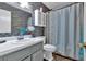 Bathroom featuring a vanity, toilet, and a shower with a white shower curtain and stone patterned walls at 316 Shiloh Hills Nw Dr, Kennesaw, GA 30144