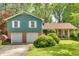 Charming home with a two-car garage, lush green lawn, and beautiful landscaping offering great curb appeal at 316 Shiloh Hills Nw Dr, Kennesaw, GA 30144
