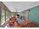 Comfortable screened porch with rustic furnishings and views of the wooded surroundings at 316 Shiloh Hills Nw Dr, Kennesaw, GA 30144