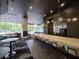 Chic bar area with counter seating, modern pendant lighting, and sophisticated ambiance for residents to enjoy at 3324 Peachtree Ne Rd # 3001, Atlanta, GA 30326