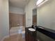Bathroom featuring a shower-tub combo, black vanity, and tile floors at 3324 Peachtree Ne Rd # 3001, Atlanta, GA 30326