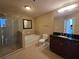 Elegant bathroom with a soaking tub, separate shower, and a granite-topped vanity at 3324 Peachtree Ne Rd # 3001, Atlanta, GA 30326