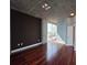 Modern bedroom with hardwood floors, neutral walls, and city views from large windows at 3324 Peachtree Ne Rd # 3001, Atlanta, GA 30326