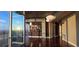 Spacious living room featuring hardwood floors, floor-to-ceiling windows with a beautiful view, and modern pendant lighting at 3324 Peachtree Ne Rd # 3001, Atlanta, GA 30326