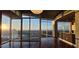 Open living room featuring hardwood floors, floor-to-ceiling windows with a stunning sunset view and pendant lighting at 3324 Peachtree Ne Rd # 3001, Atlanta, GA 30326