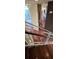A staircase with metal railings offers a glimpse of hardwood floors and the bright kitchen beyond at 3324 Peachtree Ne Rd # 3001, Atlanta, GA 30326