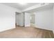 Spacious carpeted bedroom with neutral walls and doors to adjacent rooms at 3781 Cherokee Trl, Suwanee, GA 30024