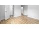 Bright bedroom featuring wood-look flooring, white walls, and doors, offering a clean and modern aesthetic at 3781 Cherokee Trl, Suwanee, GA 30024