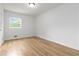 Bedroom featuring wood-look flooring, neutral walls, and a window providing natural light at 3781 Cherokee Trl, Suwanee, GA 30024