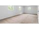 Bright bedroom featuring three windows and neutral carpeting providing natural light and comfort at 3781 Cherokee Trl, Suwanee, GA 30024