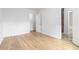 Bright bedroom featuring wood-look flooring, white walls, and doors, offering a clean and modern aesthetic at 3781 Cherokee Trl, Suwanee, GA 30024