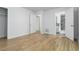 Bright bedroom featuring wood-look flooring, white walls, and doors, offering a clean and modern aesthetic at 3781 Cherokee Trl, Suwanee, GA 30024