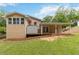 Rear exterior of home features back porch and manicured lawn at 3781 Cherokee Trl, Suwanee, GA 30024