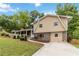 Attractive home featuring a brick facade, light-colored siding and a long driveway leading to a beautiful yard at 3781 Cherokee Trl, Suwanee, GA 30024