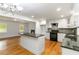 Beautiful kitchen with white cabinets, granite countertops, stainless steel appliances and easy access to the living area at 3781 Cherokee Trl, Suwanee, GA 30024