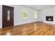 Bright living room boasts hardwood floors, a fireplace, and a decorative front door with natural light from two windows at 3781 Cherokee Trl, Suwanee, GA 30024