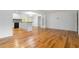 Spacious living area with gleaming hardwood floors, a convenient kitchen island, and a staircase to the upper level at 3781 Cherokee Trl, Suwanee, GA 30024
