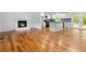 Open floorplan featuring hardwood flooring, a modern fireplace, and seamless access to a stylish, updated kitchen at 3781 Cherokee Trl, Suwanee, GA 30024
