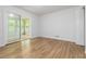 Bright room features laminate flooring, a sliding glass door to a sunroom, and a closet for optimal storage at 3781 Cherokee Trl, Suwanee, GA 30024