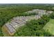 Expansive aerial view of a community surrounded by dense forest, highlighting its neighborhood layout at 1589 Bennett Creek Overlook, Suwanee, GA 30024