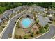 Aerial view of a community pool area with ample seating, surrounded by homes and lush landscaping at 1589 Bennett Creek Overlook, Suwanee, GA 30024