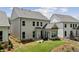 Spacious backyard showing the home's rear elevation, with a patio, and well-manicured landscaping, ideal for relaxation at 1589 Bennett Creek Overlook, Suwanee, GA 30024
