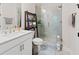 This modern bath includes an enclosed glass shower and modern fixtures at 1589 Bennett Creek Overlook, Suwanee, GA 30024