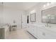 Well-lit bathroom with double vanity, white cabinets, and separate shower and bathtub at 1589 Bennett Creek Overlook, Suwanee, GA 30024