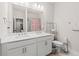Bathroom featuring double sink vanity, granite countertops, and colorful shower, perfect for modern living at 1589 Bennett Creek Overlook, Suwanee, GA 30024