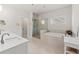 Bright bathroom with double sink vanity, soaking tub, and glass-enclosed shower at 1589 Bennett Creek Overlook, Suwanee, GA 30024