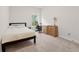 Bright bedroom featuring plush carpet, a well-lit desk area, and a cozy bed near a window at 1589 Bennett Creek Overlook, Suwanee, GA 30024