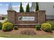 Brick community entrance sign with manicured landscaping and clear community branding at 1589 Bennett Creek Overlook, Suwanee, GA 30024