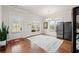 Bright dining area features hardwood floors, large windows, and an exterior door at 1589 Bennett Creek Overlook, Suwanee, GA 30024