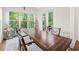 This dining area features large windows, glass pane doors, and a stylish modern décor at 1589 Bennett Creek Overlook, Suwanee, GA 30024